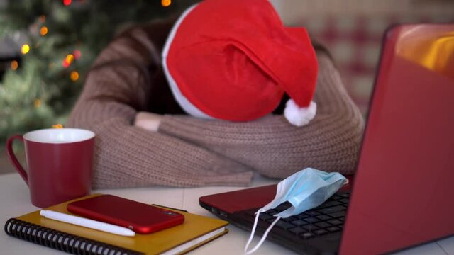 female studentin santa hat makes conference video call on laptop computer talks with web tutor, online teacher in remote webcam chat on screen. Distance education class concept.