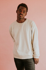 African American man wearing white sweater mockup on pink background