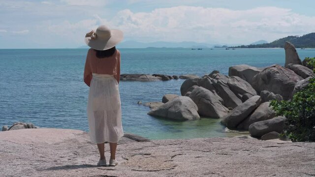 Women stand alone on the beach. Sad and disappointed woman standing by the sea