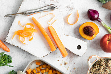 Peeled carrot baked sweet potatoes cooked quinoa flat lay