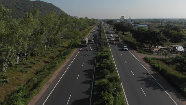 Flying up the middle lane of highway in rural area of India