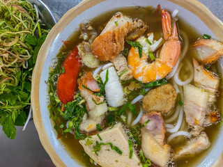 Bowl of delicious Vietnamese seafood noodles soup