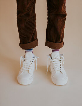 White Sneakers With Untied Laces On Man Model