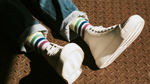 High top white sneakers on model casual style