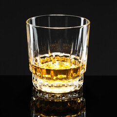 Golden scotch whisky on a black background