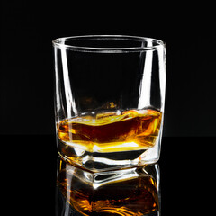 Golden scotch whisky on a black background