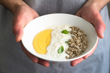 corn porridge with cheese and halva for breakfast.