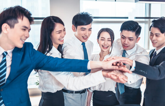 successful business team showing unity by hands together