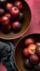 Red plums in a bowl summer food flatlay
