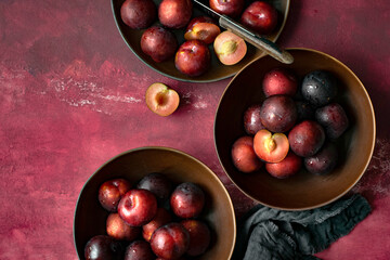 Red plums in a bowl summer food flatlay