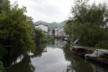 View of representative Ancient village Likeng with river and boats in Wuyuan county, Jiangxi province, China.