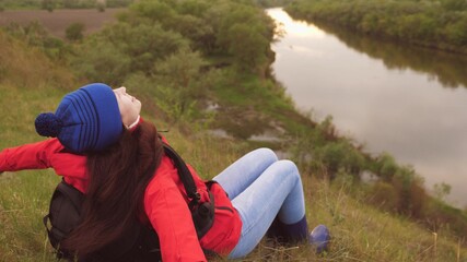 The girl traveler sits high on the mountain. Conquer new places. Active holiday weekend. Free woman tourist looking for adventure in life. The woman is alone. Pandemic