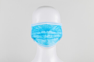 Blue surgical face mask on a mannequin