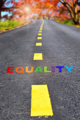 Equality word written on highway road on autumn season background. Social issue concept and lgbt idea