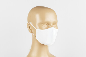 White fabric face mask on a mannequin