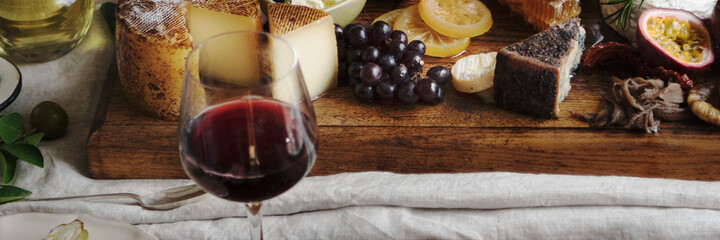 Platter of cheese with seasonal fruits and wine