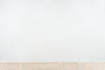 White blank concrete wall mockup with a wooden floor