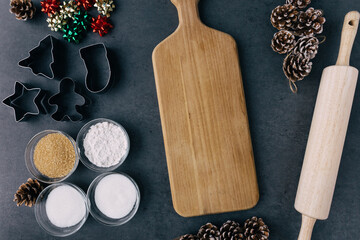 Christmas Cookie Cutters with Cutting Board and Rolling Pin on Dark Slate Texture
