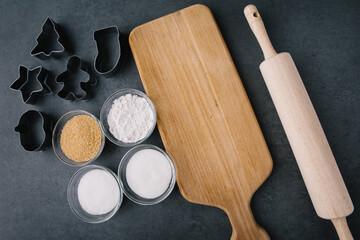 Christmas Cookie Cutters with Cutting Board and Rolling Pin on Dark Slate Texture