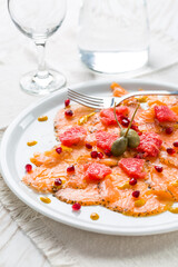 Salmon carpaccio with pink grapefruit and pomegranate