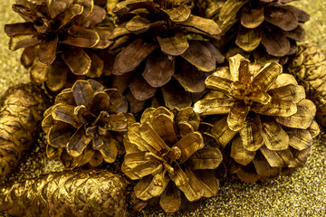  Christmas decorations with Pine Cone fortuna gold color as texture background