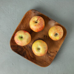 Fresh apples in a wooden plate. Still life apples on a plate