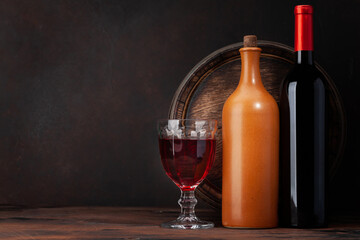 Wine bottles and old wooden barrel