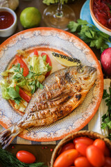 The fish dish is fried fish. Eastern cuisine. beautiful serving of fried fish in a restaurant