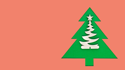 Christmas tree cut out of paper on a pink background. Silhouette of Green christmas tree. Christmas tree paper cutting design card. Paper Art with copy space. Long wide banner