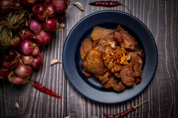 Low light photography of Pork fried with garlic ready for serve