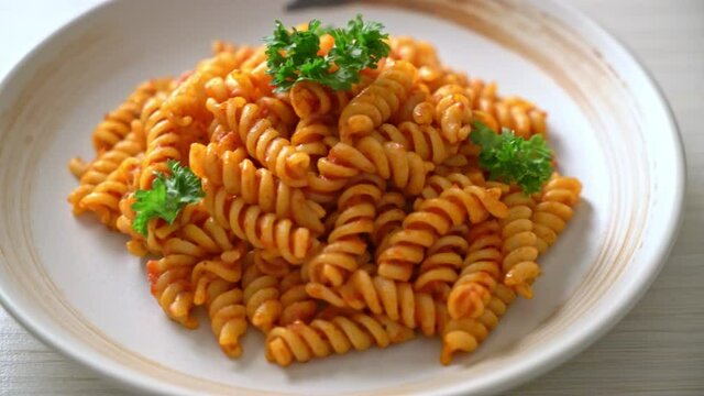 spiral or spirali pasta with tomato sauce and parsley - Italian food style