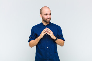 bald man scheming and conspiring, thinking devious tricks and cheats, cunning and betraying
