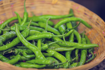 Fresh green chilly in wooden bowl