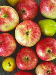 Delicious country apples and pears closeup on the bench.