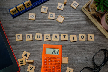Alphabets spelled EDUCATION flat lays on wooden background layouts.