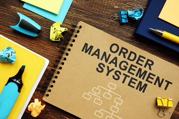Order Management System OMS papers with charts on the desk.