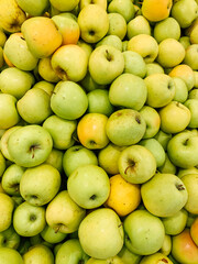 lots of ripe green apples for cooking as a background
