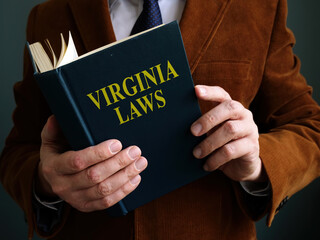 The man is reading Virginia law book.