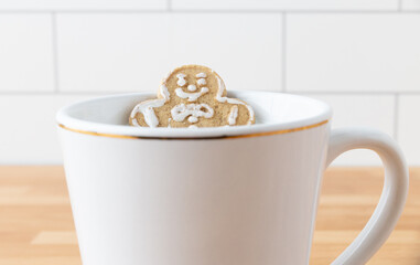 Christmas Holiday Gingerbread Man Cookie Sitting In Mug With Milk On Dark Slate Background