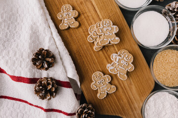 Christmas Gingerbread Man Cookies on Wooden Board With Ingredients