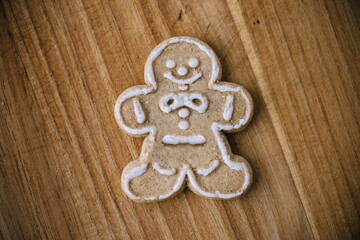 Single gingerbread man cookie on wooden cookie board