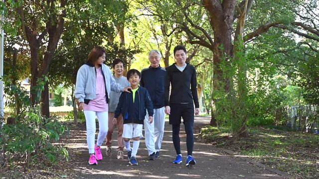 公園を散歩する健康的な３世代家族	