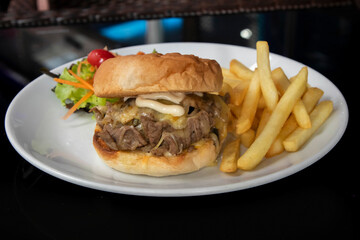 Steak sandwich with French fries and salad