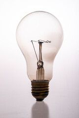 Old glass bulb with tungsten filament. Accessories for the lighting system in the household.