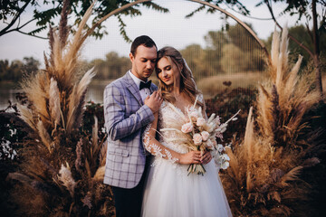 Attractive couple newlyweds, happy and joyful moment. Man and woman in festive clothes near the...