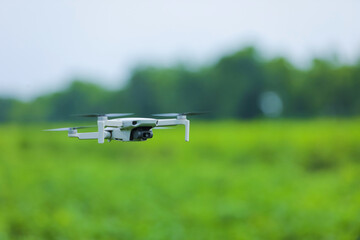 Close up view of flying drone over agriculture field