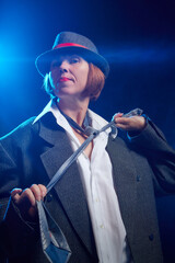 Portrait of ugle middle-aged woman with hat. Model posing in funny male style in the Studio.