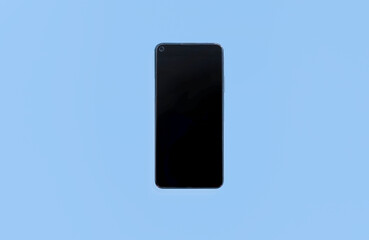 Naklejka premium Black smartphone isolated on light blue background, the top view. Flat lay. copy space