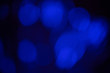 Blue light bokeh in black background. Copy space.