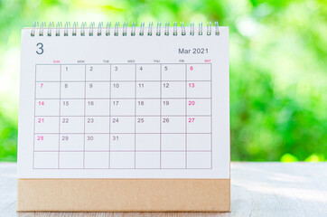 Calendar desk 2021 March month for organizer to plan and reminder on wooden table on nature...
